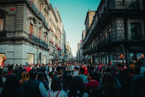 Lively street scene with a bustling crowd on Madero Street, Mexico City, capturing urban life.