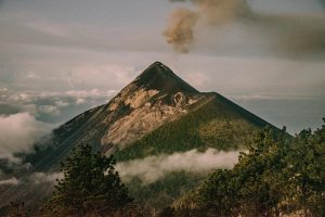Capture of the erupting Volcán de Fuego in Guatemala with a scenic landscape.