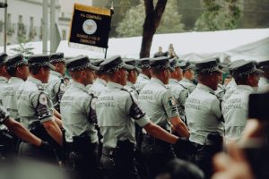 A group of uniformed National Guard soldiers marching in formation during a parade.