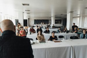 A diverse group of business professionals attending a presentation in a modern conference room.