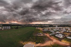 Panoramic aerial view of Campo Mourão, Brazil with dramatic skies and rural landscapes at sunset.