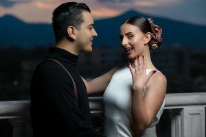 Joyful couple celebrating their engagement outdoors in Morelia, Mexico, during sunset.