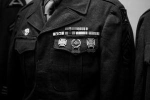 Close-up of a military uniform adorned with medals in a black and white photograph.