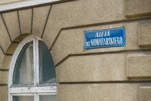 Detail of a vintage stone wall with a street sign in Krynica-Zdrój, Poland.