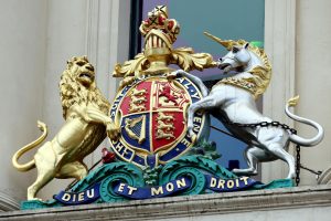 Close-up of the Royal Coat of Arms featuring a lion and unicorn on a Melbourne building facade.