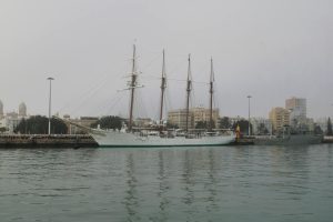 Elegant tall ship docked at Cádiz harbor, Spain, showcasing classic nautical architecture.