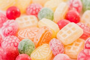 A close-up view of assorted colorful hard candies with various shapes and colors.