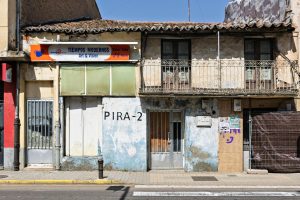 A rustic facade of Tiempos Modernos Video Club in Guijuelo, Spain, featuring vintage architecture and signage.