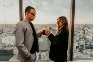 Stylish couple enjoying drinks and sunset on a rooftop in Buenos Aires.