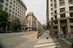 A vibrant street view in Buenos Aires, featuring classic architecture and urban life.