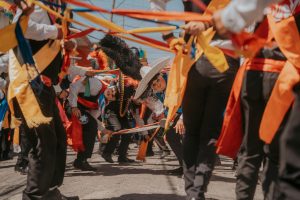 Vibrant street dance performance with traditional Mexican attire in Puebla, Mexico.