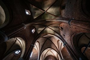A striking view of gothic arches and brickwork inside a historic cathedral, showcasing architectural elegance.