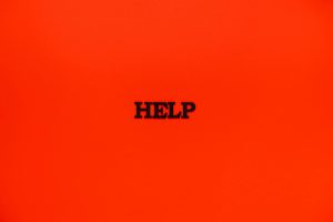 Minimalist red background featuring the word 'HELP' in bold text.