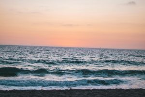 Calm waves and a vibrant sky at sunset on Hermosa Beach, CA.
