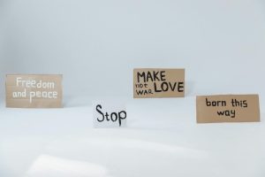 Cardboard signs promoting peace, love, and acceptance, perfect for activism and social movements.