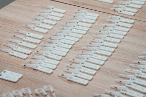 Multiple COVID-19 test kits displayed neatly on a wooden table indoors.