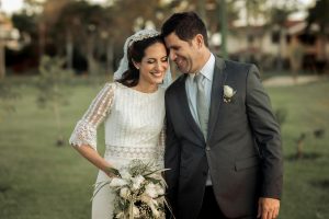 Happy bride and groom sharing a tender moment outdoors, capturing love and joy.