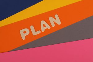Vibrant geometric colored background with the word 'Plan' in bold letters, perfect for business concepts.