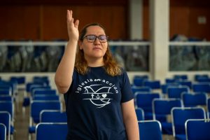 A woman in glasses prays at an empty church in Ciudad de México, capturing a moment of faith.