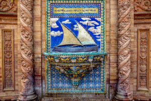 Intricate ceramic art depicting a sailing ship at Plaza de España, Seville.
