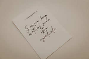 Minimalist photo of an inspirational calligraphy note on white paper.