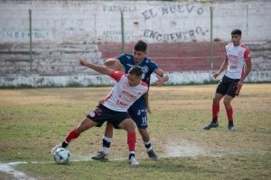Young athletes engage in a competitive soccer match on a grassy field, displaying skill and teamwork.
