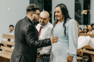 An intimate moment captured between family members during a wedding ceremony.