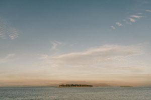 Beautiful view of a serene island and ocean under a glowing sunrise in Fiji.