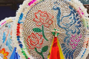 Colorful traditional Mexican parasol decorated with intricate designs in Zozocolco de Hidalgo, Veracruz.