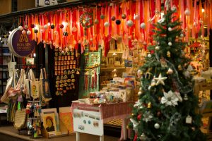 Vibrant market stall adorned with Christmas decor and educational materials.