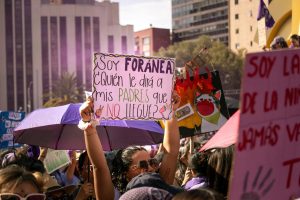 Colorful protest for women's rights in Mexico City with diverse signs and messages.