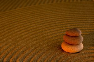 Peaceful zen garden with stacked stones and raked sand in València, Spain.