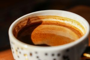 Warm and inviting close-up of espresso coffee in a patterned cup with rich crema.