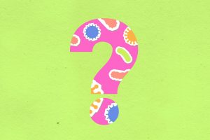 From above of decorative cardboard appliques of question mark with various oval shaped cells and microbes