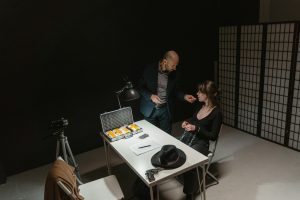 An intense interrogation with evidence on the table, showcasing a crime scene.
