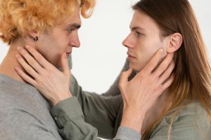 Close-up of two young adults gazing into each other's eyes, highlighting connection.