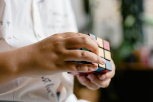 Hands manipulating a Rubik's Cube, showcasing concentration and skill.