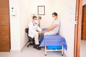 Doctor checking patient's vitals in a clinical setting for health consultation.