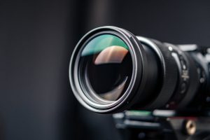 Detailed close-up of a professional camera lens with clear reflections.