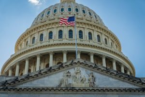 Close-up view of the iconic United States Capitol dome with American flag in Washington, D.C.