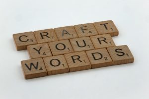 Creative arrangement of word tiles spelling 'Craft Your Words' on a white background.