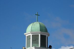 The iconic dome of St. Peter's Church in Lancaster, Ohio, set against a clear blue sky.