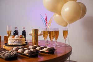 A festive Brazilian table setup with cake, drinks, sweets, and balloons, perfect for any celebration.