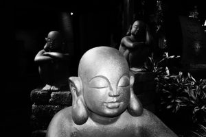 Serene black and white sculpture scene of meditating figures in Hồ Chí Minh, Vietnam.