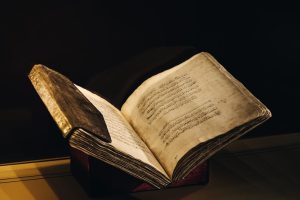 A vintage manuscript with Arabic script open to reveal beautifully aged pages, showcased elegantly.