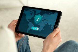 Person holding tablet with VPN connection screen for secure internet browsing.
